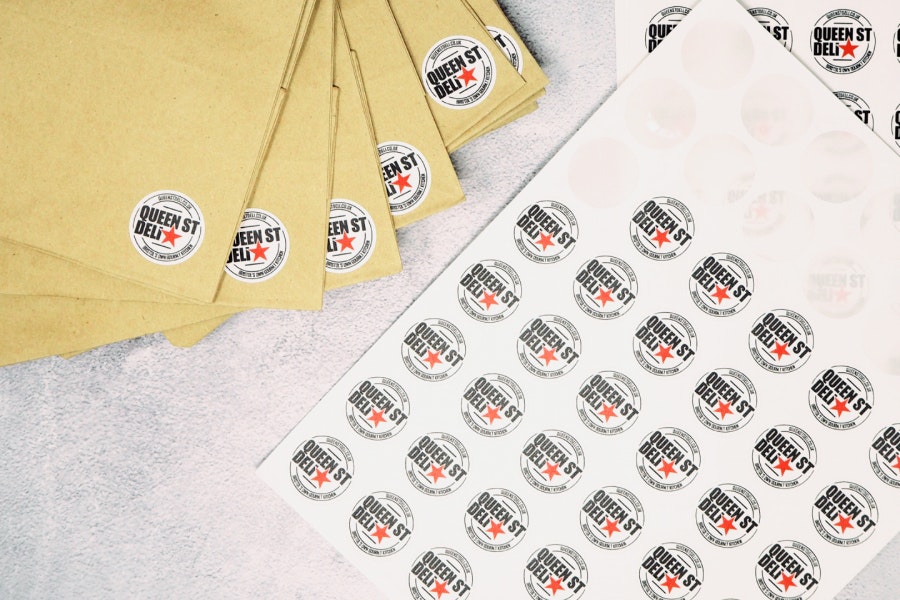 Round Biodegradable paper sheet labels applied to paper bags