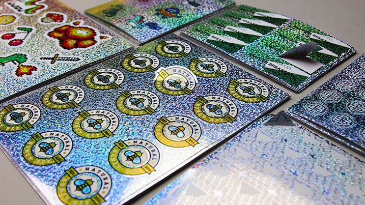 Stacks of glitter sheet labels on a table