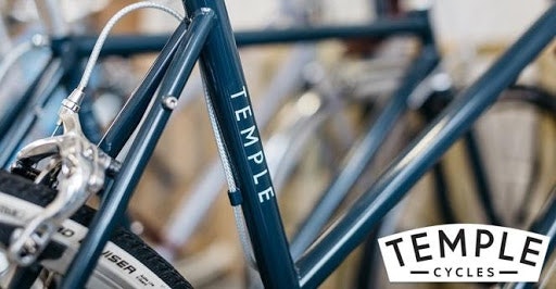 White bicycle sticker with Temples cycles logo applied to a grey bike frame used for the testimonial