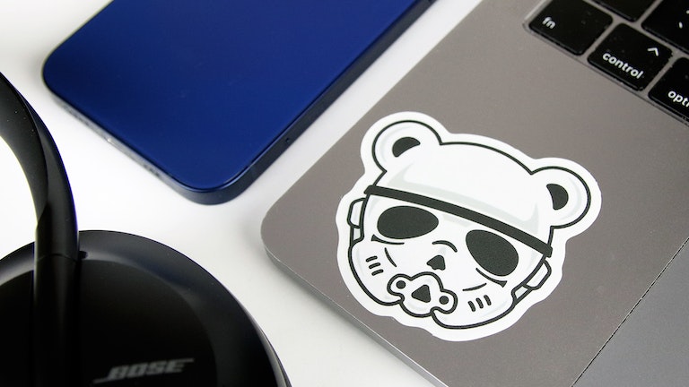 Die cut eco friendly sticker with a teddy storm trooper design applied to a silver laptop
