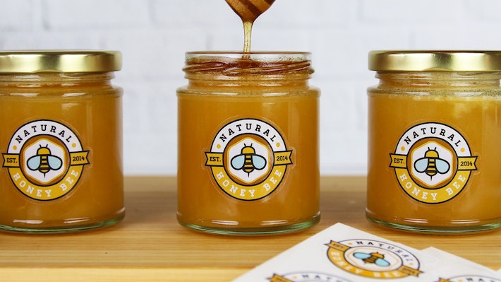 Clear eco friendly labels applied to three different honey jars