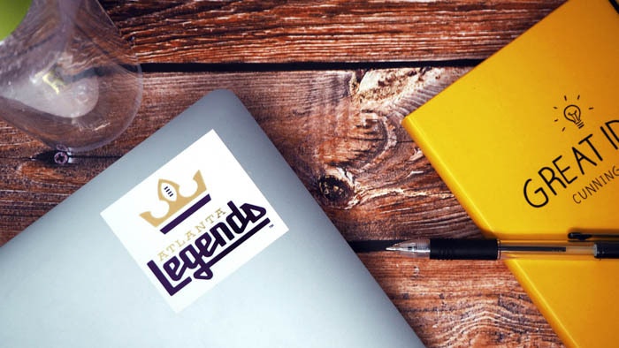 mirror gold sticker rectangular with legends logo applied to a laptop