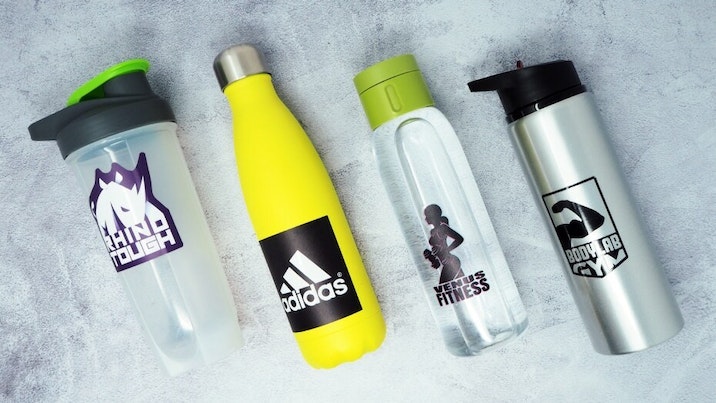 Several water bottle stickers applied to four different water bottles