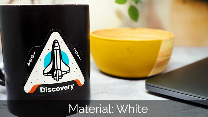 Die cut white vinyl sticker with discovery design applied to black mug