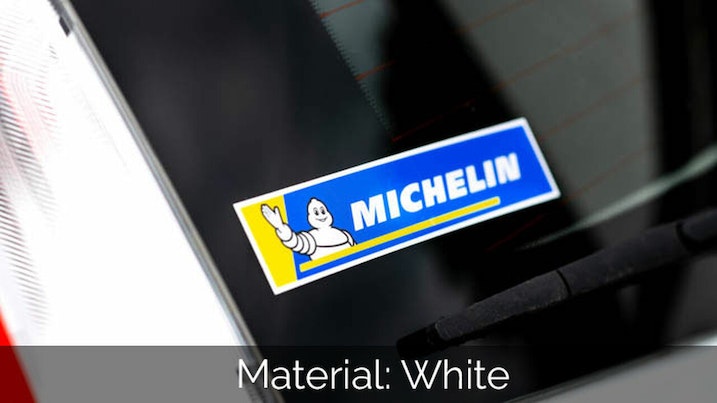 Rectangular white vinyl sticker with michelin logo applied to car window