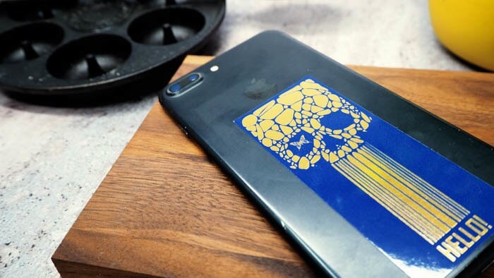 Mirror gold phone sticker with skull design applied to silver iPhone