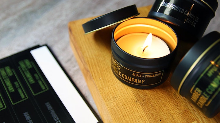 Mirror gold sheet labels applied to black tin candles