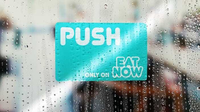 Rounded corner static cling with eat now logo applied to a window