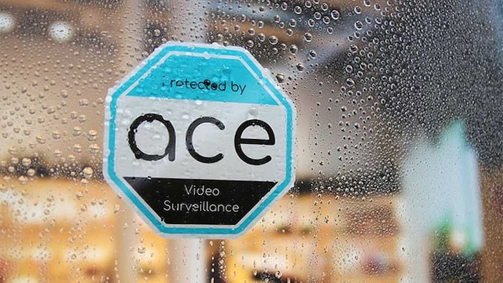 Die cut front adhesive sticker with ace design applied to a window