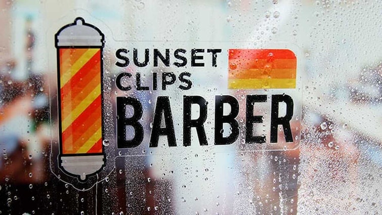 Die cut front adhesive sticker with barber logo applied to a window