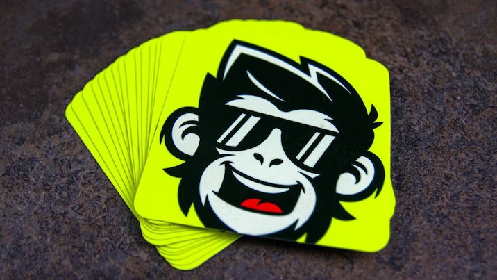 Rounded corner fluorescent yellow stickers with monkey design on a table