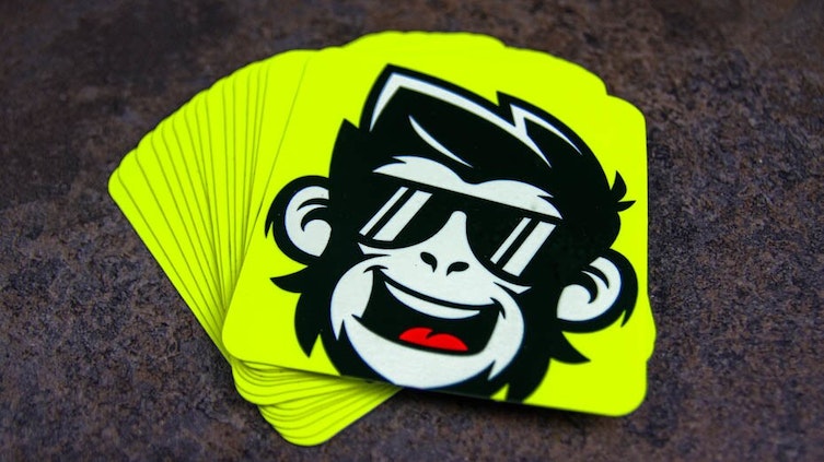 Rounded corner fluorescent yellow stickers with monkey design on a table