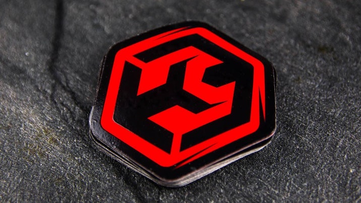 Die cut fluorescent red stickers on a table