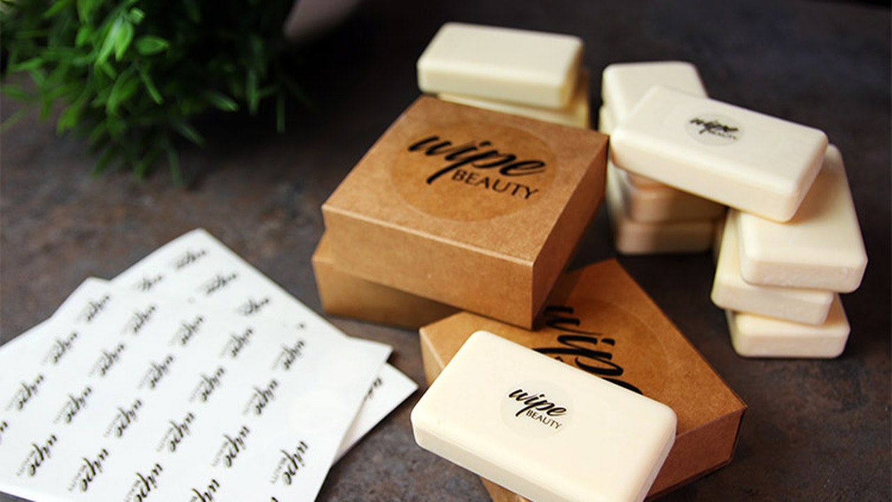 Circle clear sheet labels applied to cardboard soap boxes