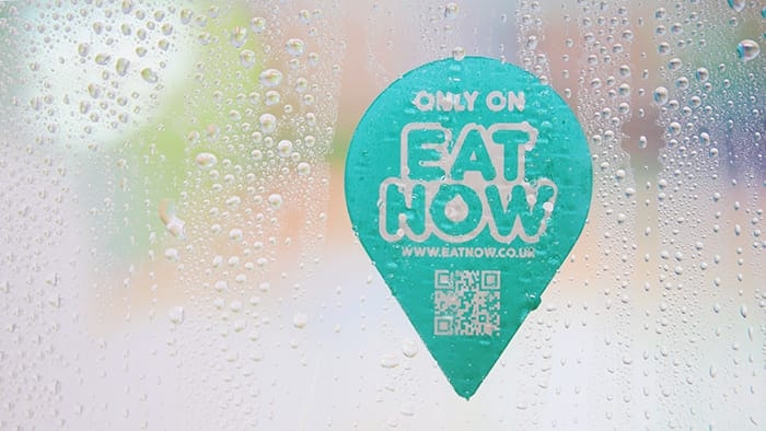 Die cut eco-friendly front adhesive stickers with eat now logo applied to a window