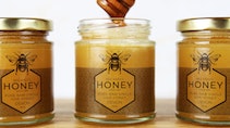 Rectangular clear label applied to three honey jars in a row