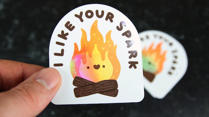 Die cut holographic sticker with i like your spark design hand held