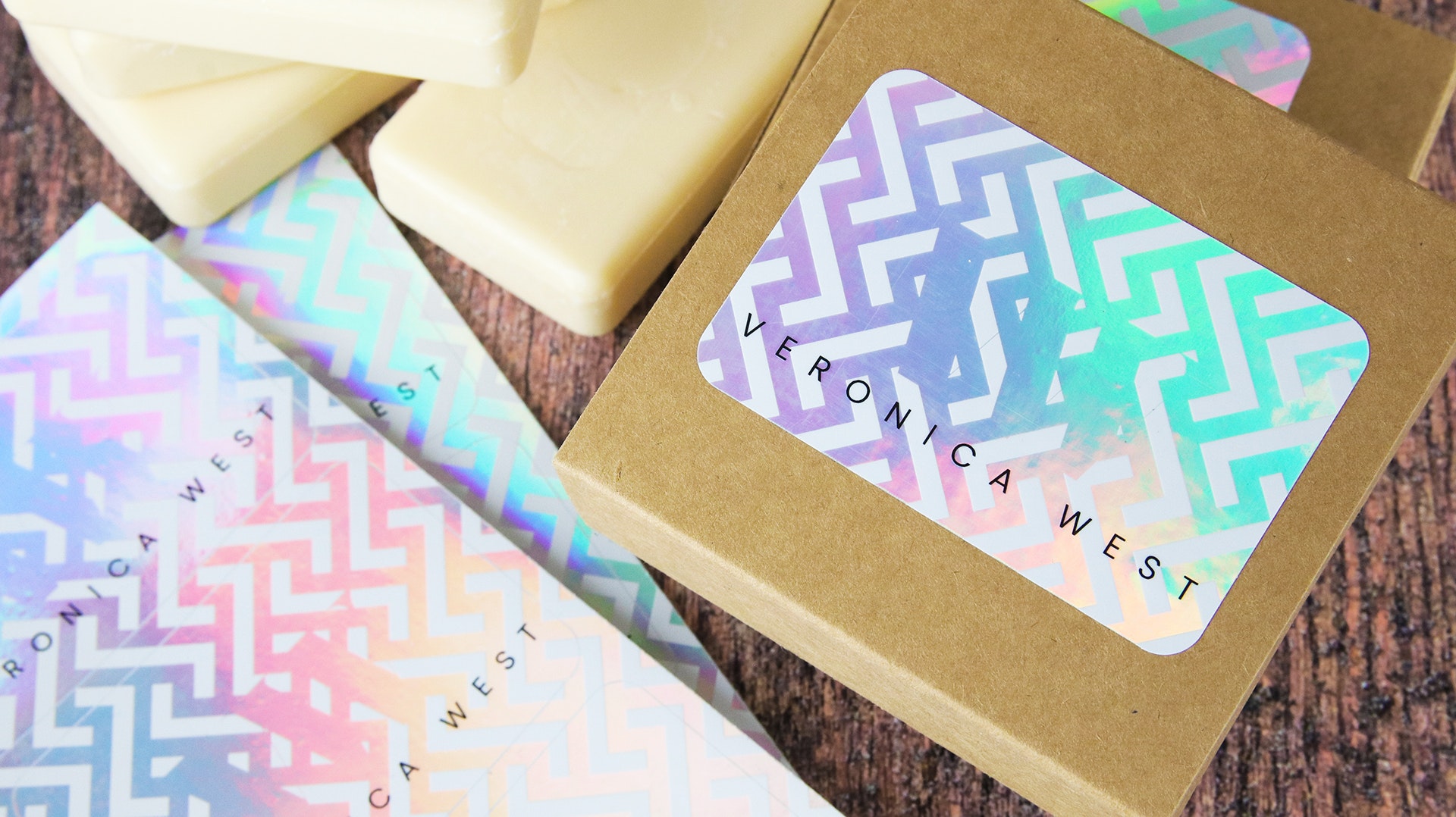Rounded corner holographic sheet labels with victoria west logo applied to cardboard soap boxes