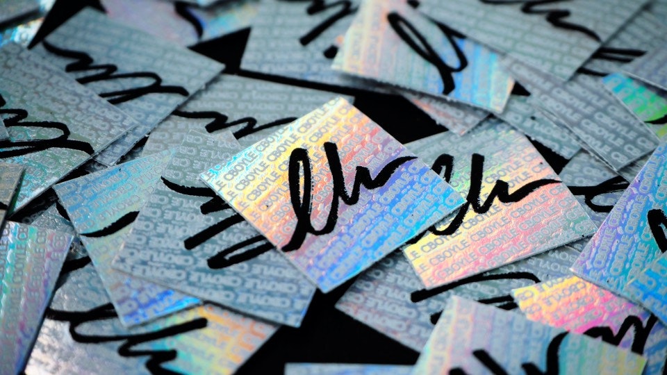 A pile of square security holographic stickers