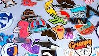 A pile of various custom printed stickers