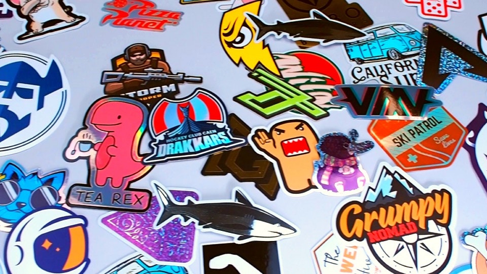A pile of various custom printed stickers