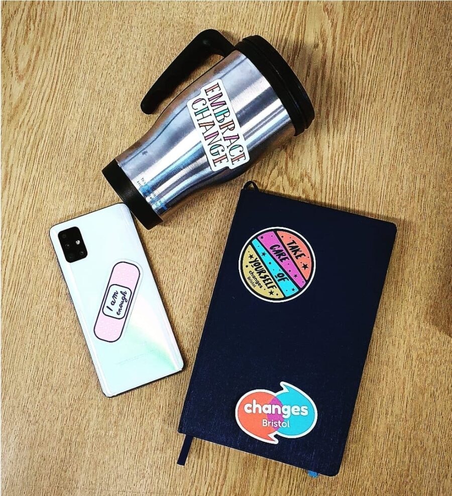 Mental health biodegradable stickers applied to a book and other objects