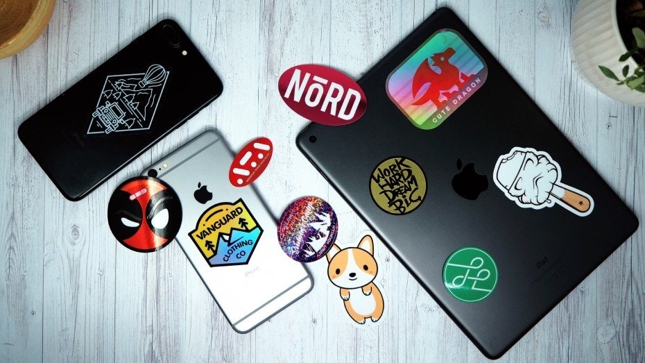 Various die cut stickers on a white wooden table