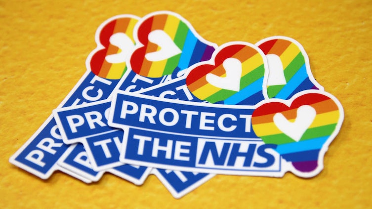 A pile of Protect the NHS die cut stickers