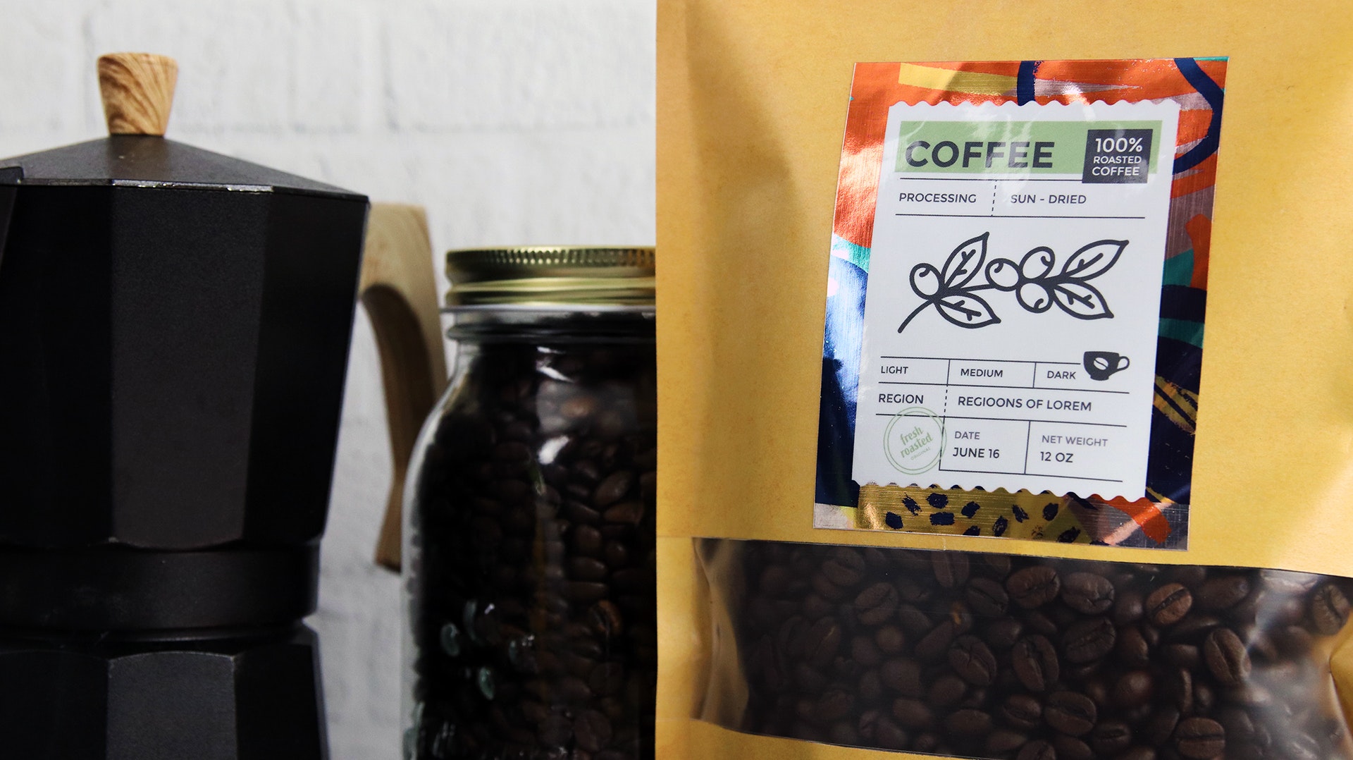 Rectangle mirror silver sticker applied to a bag of coffee next to a jar of coffee beans and an espresso maker
