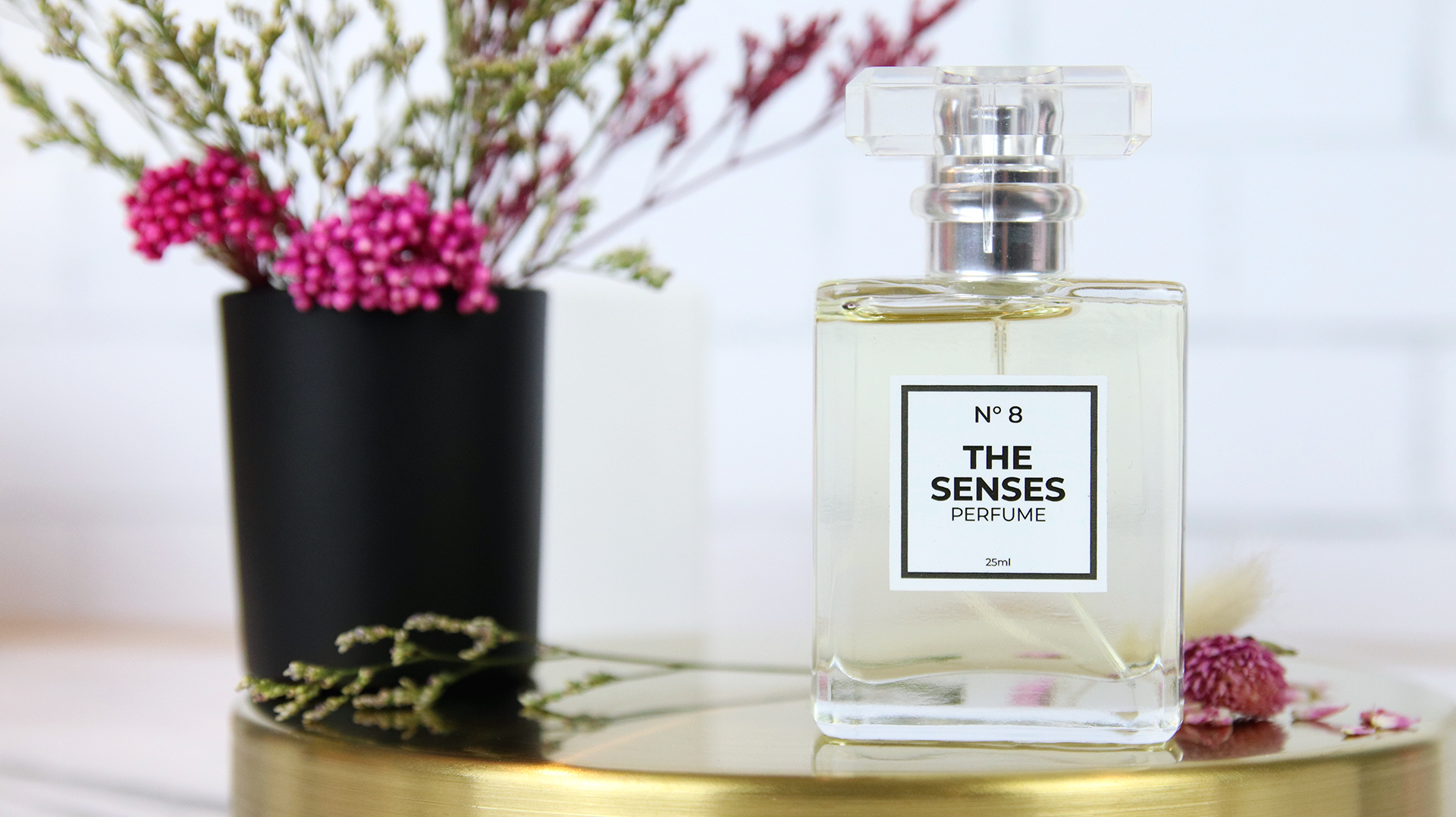 Square white vinyl sticker with the senses design applied to perfume bottle