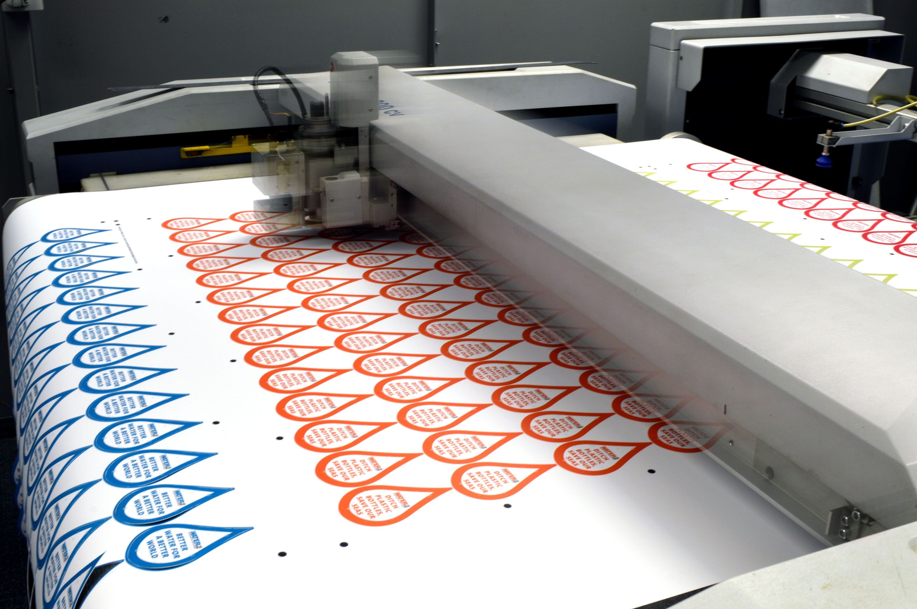 Custom stickers being printed on a flatbed cutter